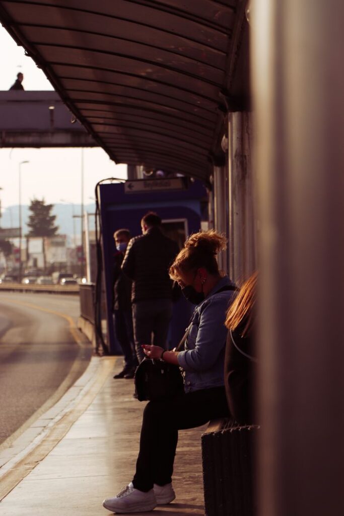 People waiting at a bus stop in Istanbul during daytime, capturing urban life.